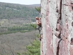 Young man rock climbing Stock Footage