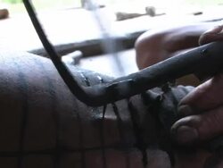 Close Up static - An artist uses a traditional method to tattoo a man's skin. / Indonesia Stock Footage