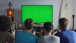 Guys sitting on couch playing video games Stock Footage