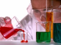 Scientist pouring red liquid into beaker Stock Footage