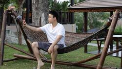 young man taking a selfie in the garden by smart phone Stock Footage