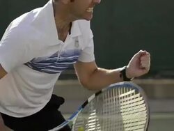 CU ECU of a man serving a tennis ball and celebrating an ace serve. Stock Footage