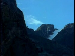 WA craggy, snow covered mountain top set against blue sky, Uganda, Africa Stock Footage