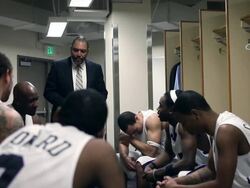 MS coach in discussion with professional basketball players in locker room / Washington, USA Stock Footage