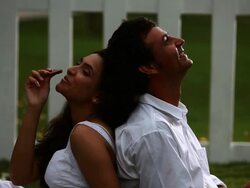 Couple eating chocolate in the garden  Stock Footage