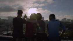 Group of friends hug and take smartphone photos overlooking Austin, Texas skyline Stock Footage