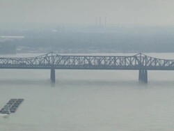 WS Tugboat moving coal filled barge towards Memphis Arkansas bridge / Memphis, Tennessee, United States Stock Footage