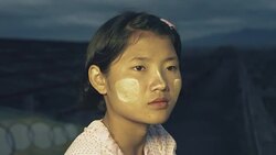 M/S Burmese teenage girl in an urban flat roof in an abandoned building at sundown Stock Footage