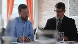 Financial advisor shows numbers and figures to restaurant owner in business meeting Stock Footage