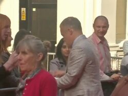 Graham Norton signing autographs on red carpet News Clip