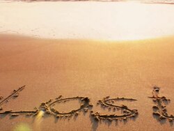 The word LOST written on beach during sunset Stock Footage
