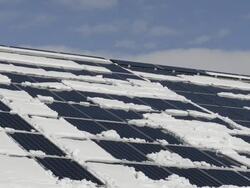 MS Shot of snow lying on roof with solar panels, photovoltaic / Landshut, Bavaria, Germany Stock Footage