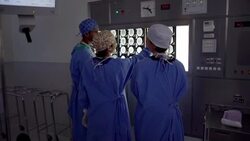 Surgeons reviewing and discussing MRI scans in operating room Stock Footage