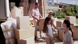 Mother comforting daughter next to moving truck Stock Footage