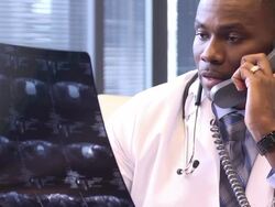 Male Doctor Discusses Radiology Slides on Phone Stock Footage