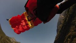 Foot pov as parachuter glides towards his landing Stock Footage