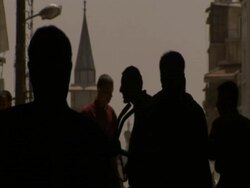 Silhouetted crowds moving under archway, Syria (sound available) Stock Footage