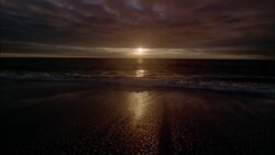 Gentle waves wash onto a beach. Stock Footage