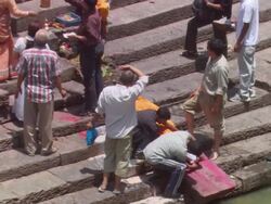 MS ZO Group preparing  body for  funeral by  river AUDIO / Kathmandu, Central Region, Nepal Stock Footage