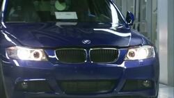 A brand new BMW drives off the assembly line in an automobile factory. Stock Footage