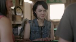 Young woman laughs with friends as poker cards are dealt Stock Footage