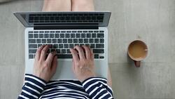 Top view Woman working on a floor with her laptop, Coffee cup Stock Footage