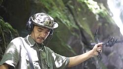 Researchers listen to the radio signal from radio telemetry,tracking to find an wildlife in tropical rainfores Stock Footage