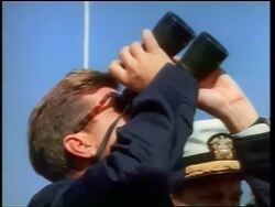 1960s close up PROFILE John Kennedy looking up with binoculars watching missile / newsreel Stock Footage