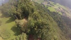 POV wingsuit flying over cliffs and alpine forests Stock Footage