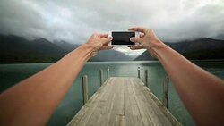 Personal perspective of person taking picture using mobile phone Stock Footage