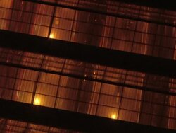 Aerial close up view of train pulling into Waterloo Station through roof / zoom out roof of station amidst railway lines, traffic and buildings / London, England Stock Footage