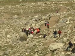 Pull Back Shot Pilgrims doing circumambulation around Mount Kailash Lhasa Tibet China Stock Footage