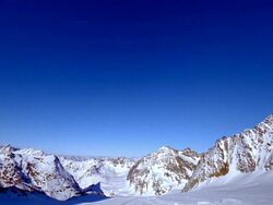 Two snowboarders passing camera Stock Footage