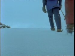 MS low angle view of spiked boots trekking through crisp snow, Rwenzori Mountains, Uganda Stock Footage