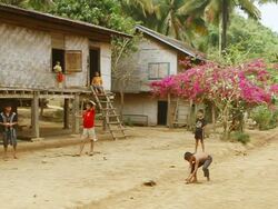 MS SLO MO Shot of group of boys playing with spinning tops / Village near Luang Prabang, Laos Stock Footage
