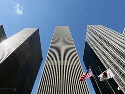 WS LA View of waving American flag and Japanese flag under skyscraper at 6th Avenue / New York, United States Stock Footage