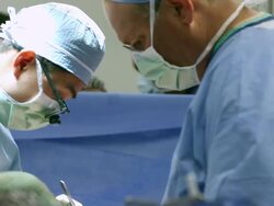 Doctors performing surgery in operating room Stock Footage