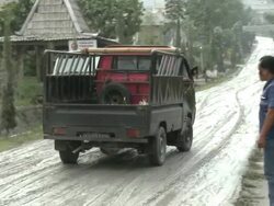 Small truck skids on volcanic ash-covered road after eruption of Merapi volcano; Indonesia. 7 November 2010 / AUDIO Stock Footage