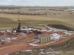 WS AERIAL DS Shot of oil drilling rig in Bakken oil field near Watford City / Watford City, North Dakota, United States Stock Footage