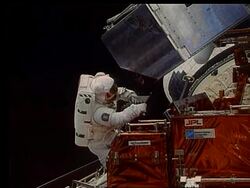 Astronaut with metal box in open Shuttle bay Stock Footage