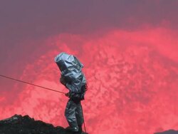 Volcanologist studies erupting lava lake up close, Marum Volcano, Ambrym Island, Vanuatu Stock Footage