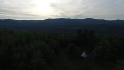 4K aerial video of a mountain landscape with a teepee on a cloudy day Stock Footage