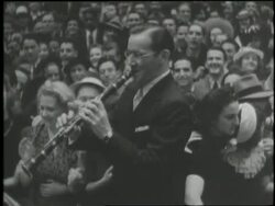 Band leader Benny Goodman plays the clarinet and couples swing dance in 1941. Stock Footage