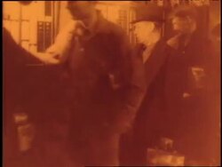 Workers punch a time clock on their way in and out of work. News Clip