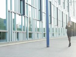 Business executive on the phone in front of office Stock Footage