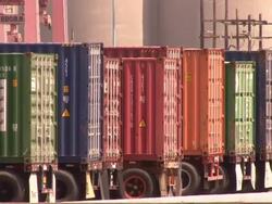 Medium pan-right - International containers with chassis line up near storage silos. / Newport, Virginia. Stock Footage