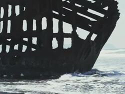 MS SLO MO Shot of old rusted shipwreck of Peter Iredale is sunk in high tide off Oregon coast / Astoria, Oregon, United States  Stock Footage
