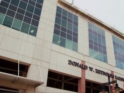 Drive by college building, "Donald W Reynolds Razorback Stadium" Stock Footage