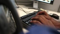 Office worker's hands type on computer keyboard Stock Footage