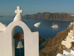 CU Shot of church bell with ship movinf in Ocean at village Oia / Santorini, Cyclades, Greece Stock Footage